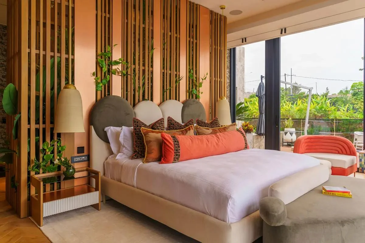 A bedroom with a colourful headboard and city views