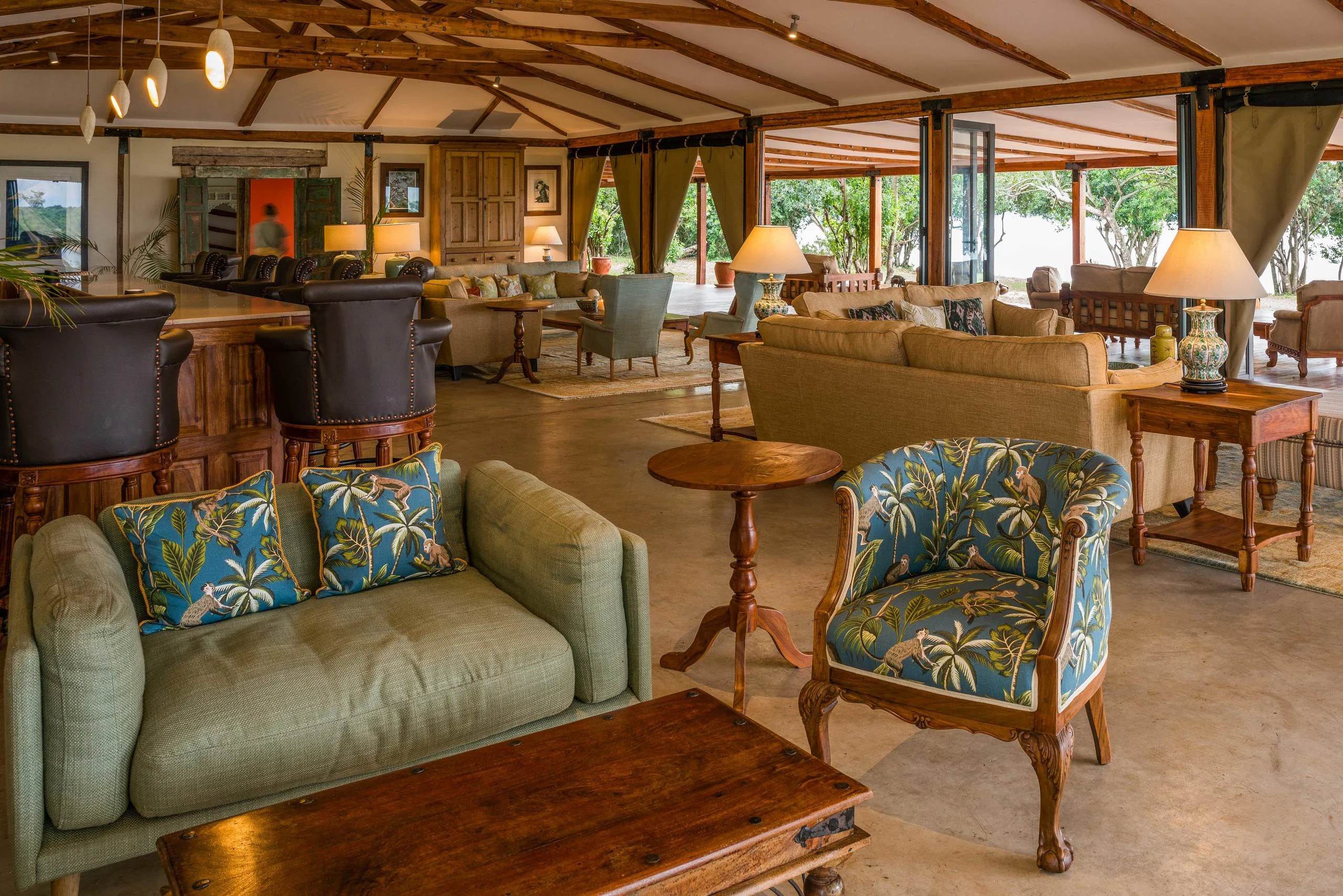 The lounge with patterned armchairs, open to the river