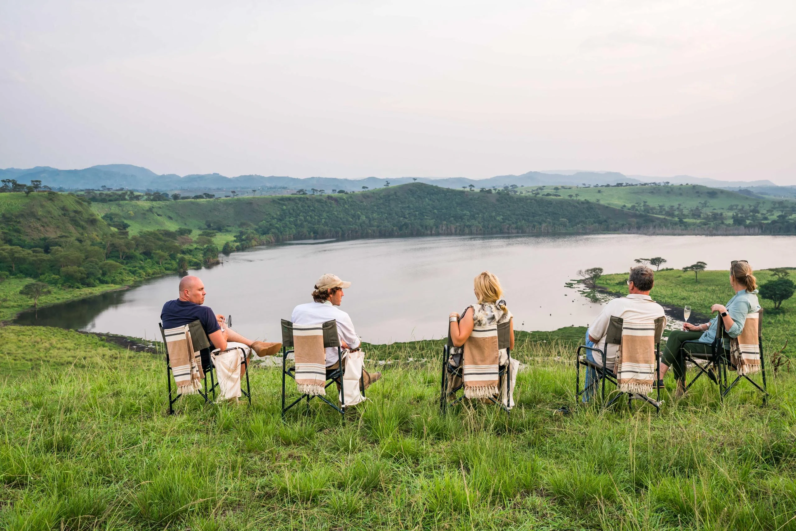 Guests in chairs above a crater lake