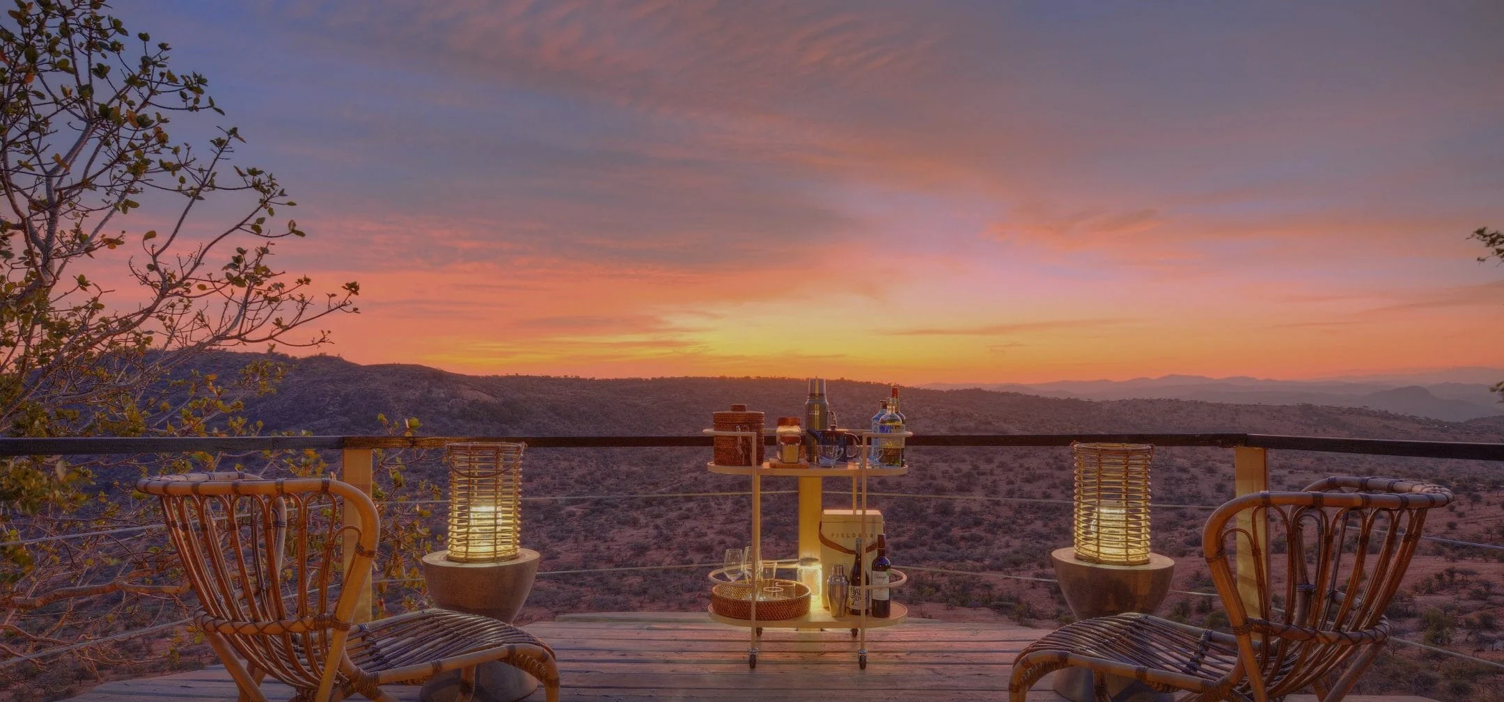 A deck laid for dinner at sunset