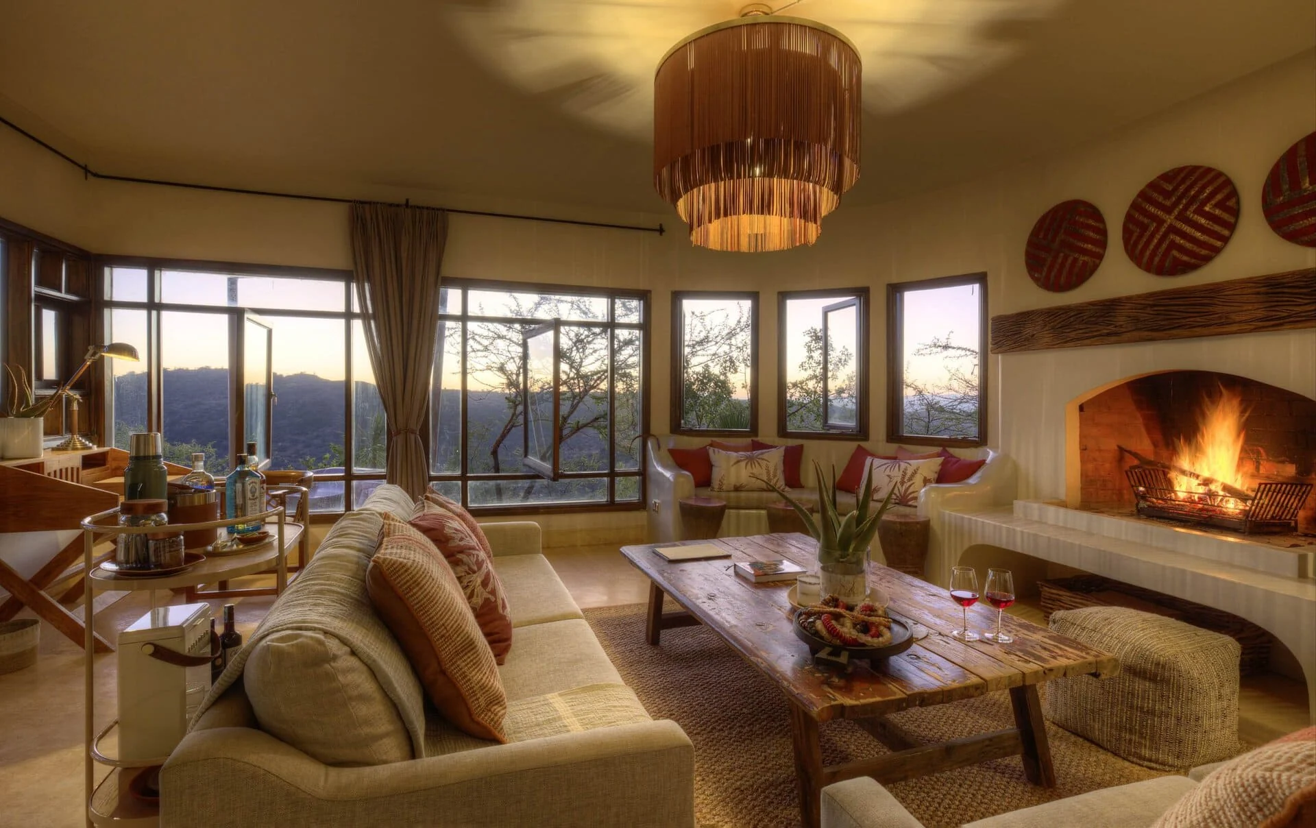 A living room with a fireplace at dusk