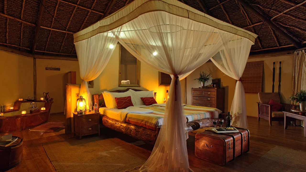 A tent bedroom with a four-poster bed