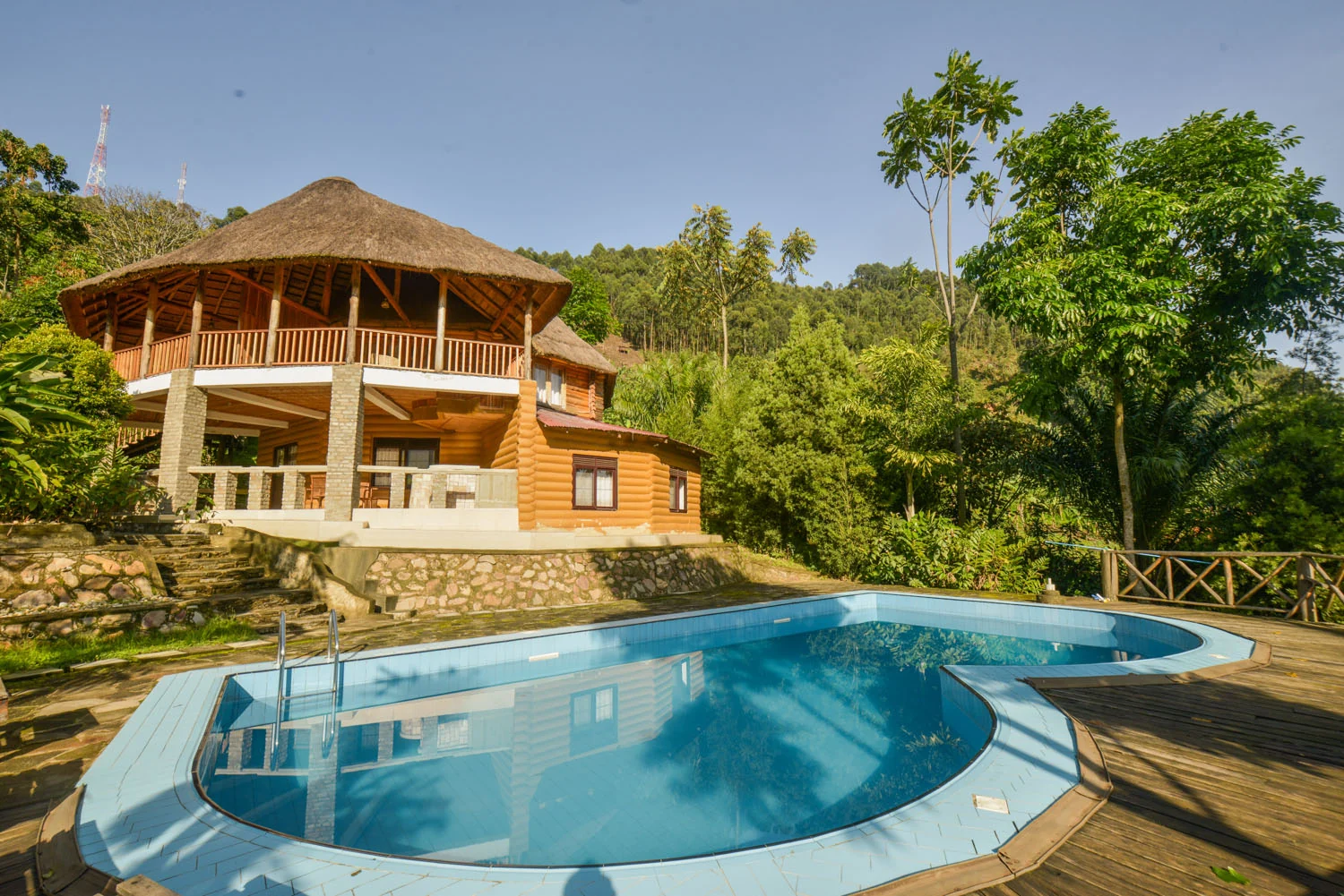 The thatched main building and pool on the hillside