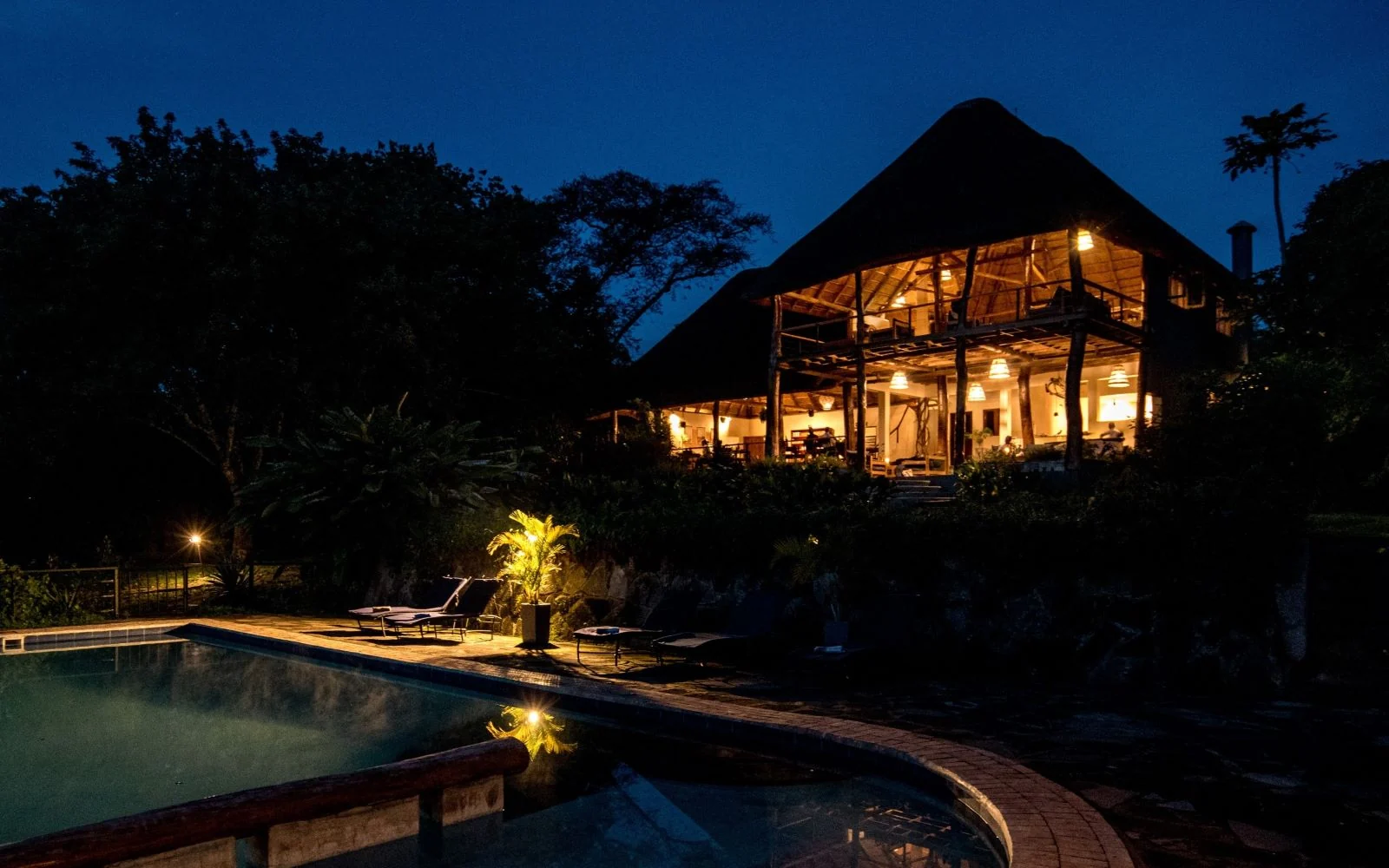 The lodge and pool lit at dusk