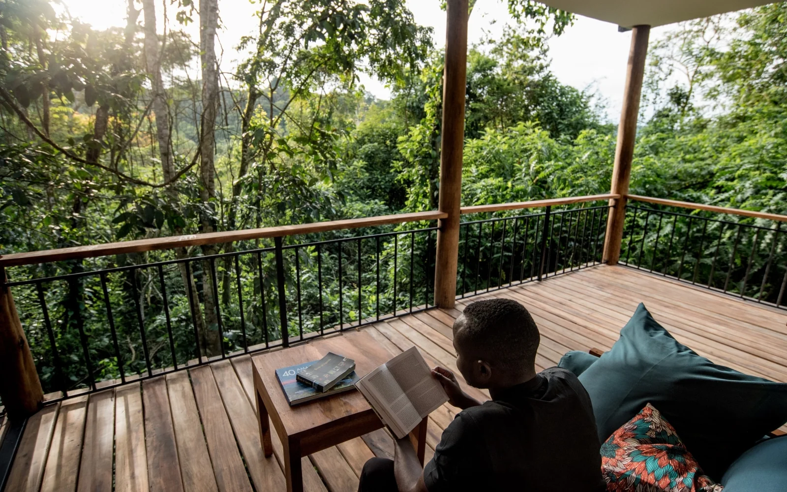 A guest reading on a cottage deck in the forest
