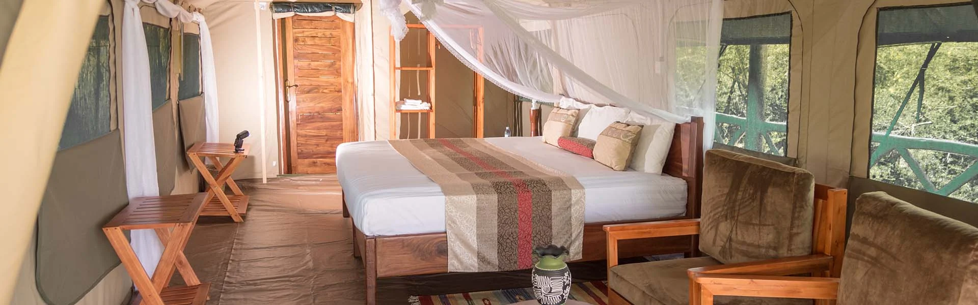 A tent bedroom with a draped bed