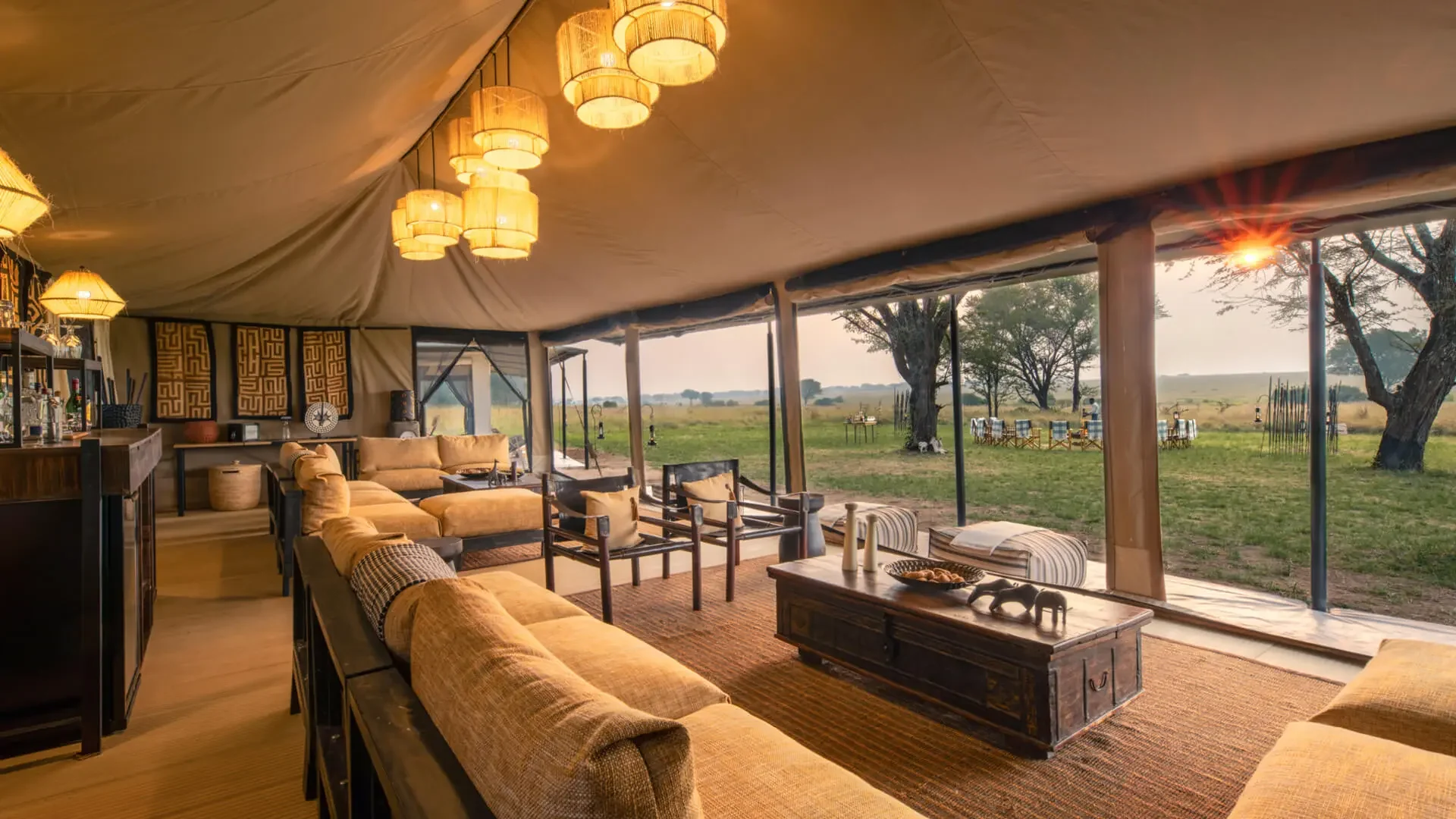The lounge tent with woven lamps, looking out to the plains