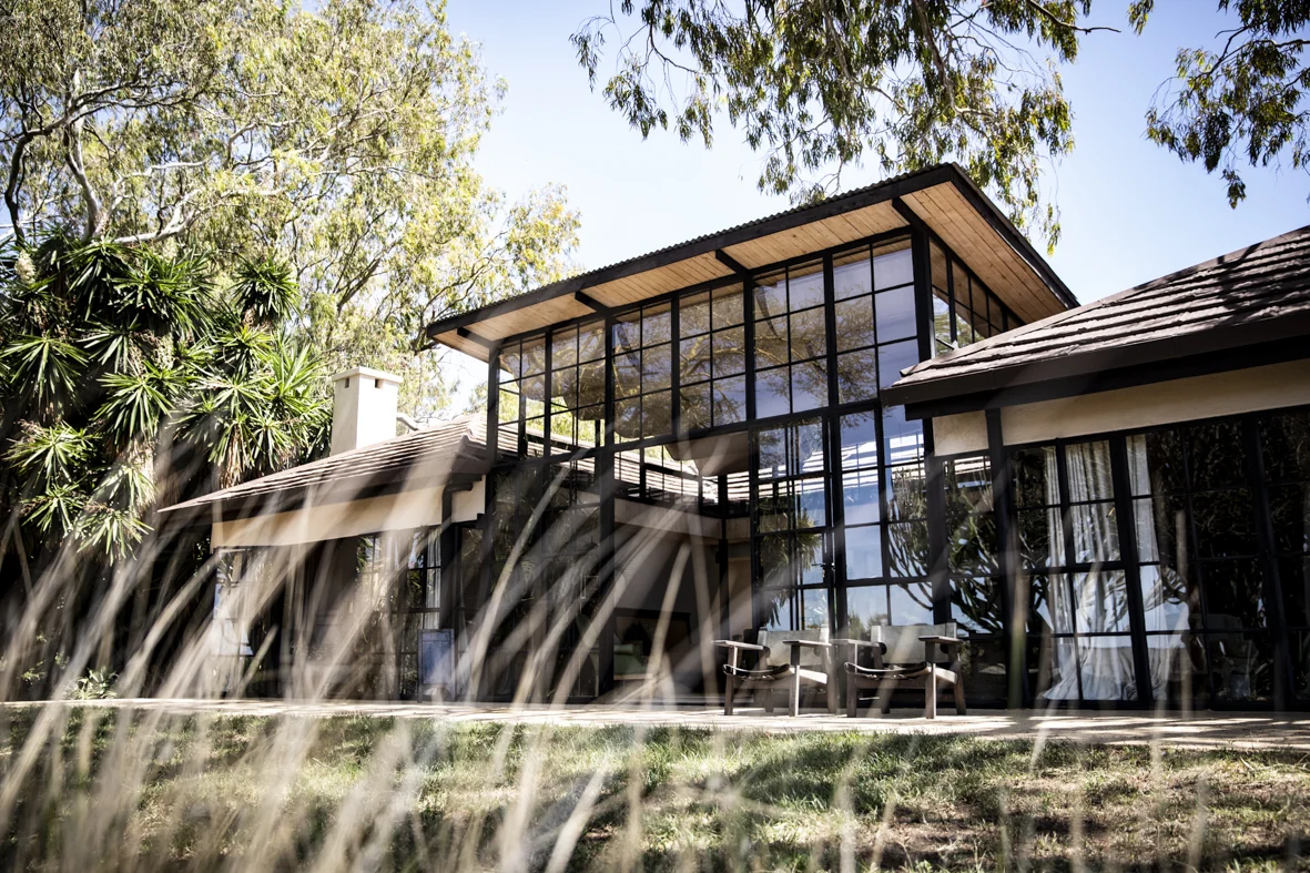 A glass-fronted house among the trees