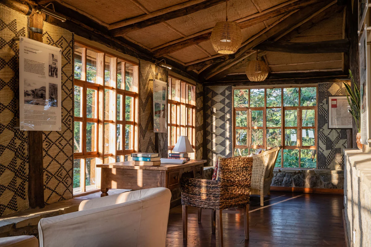 The lounge with woven chairs and windows onto the hills