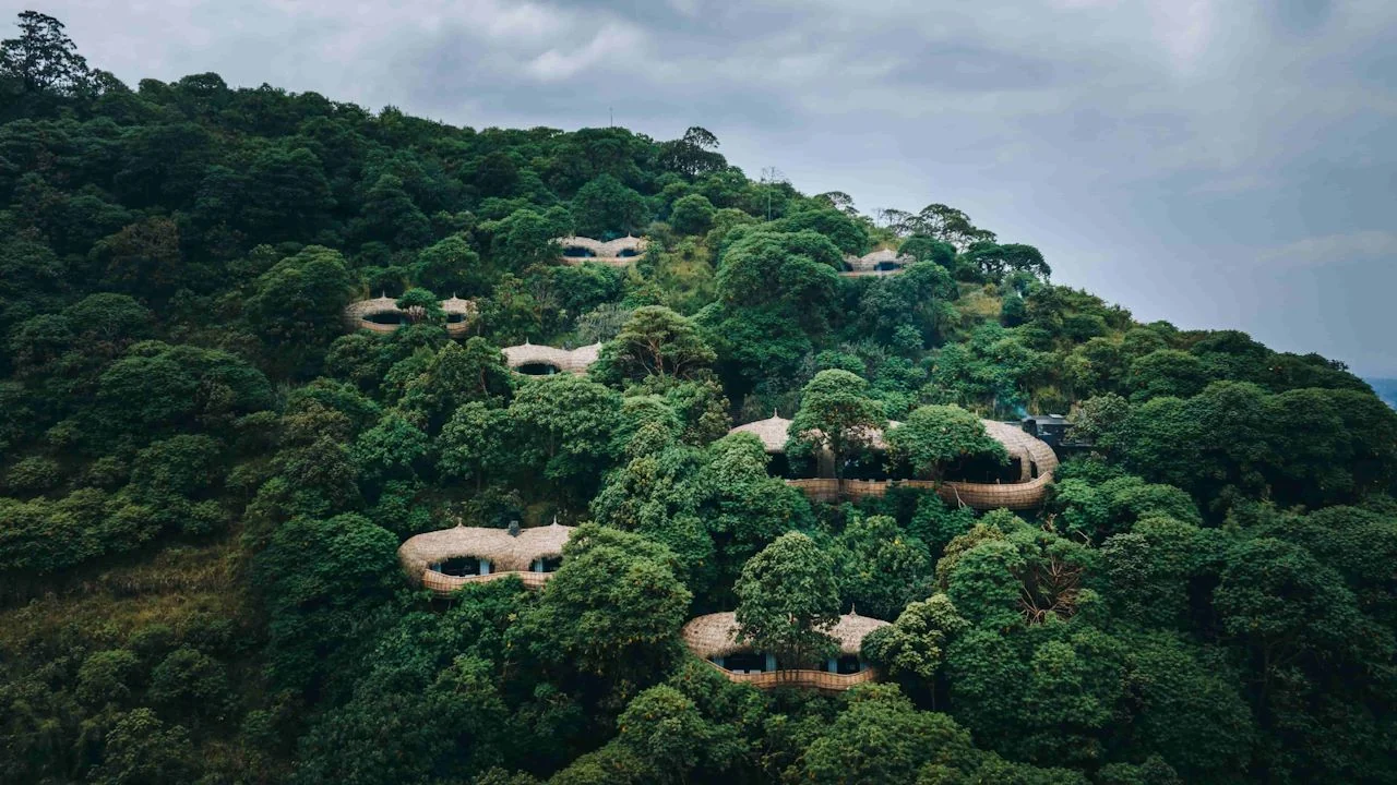 The lodge's domed villas on the forested hillside, from the air