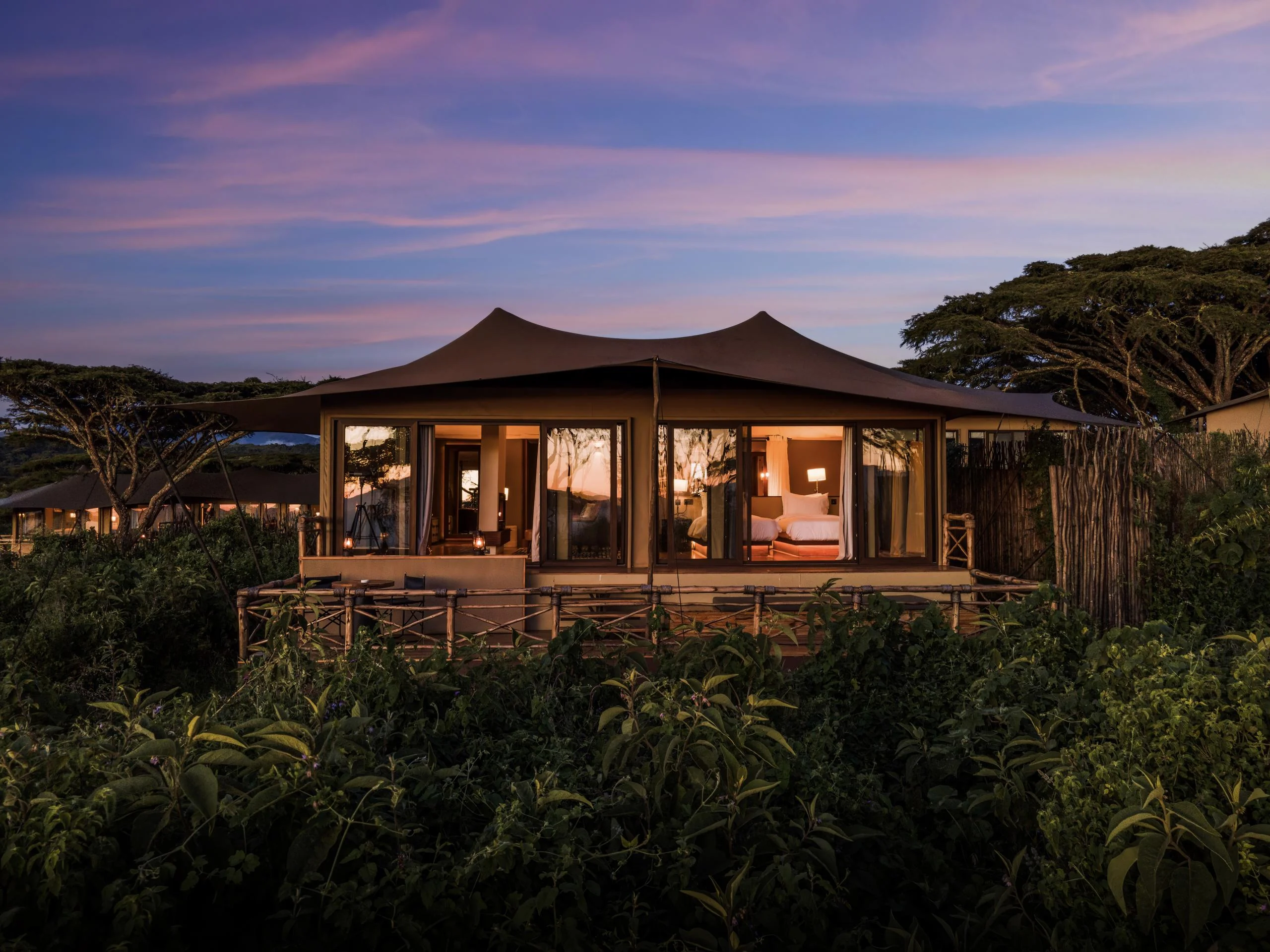 A tented suite lit at dusk