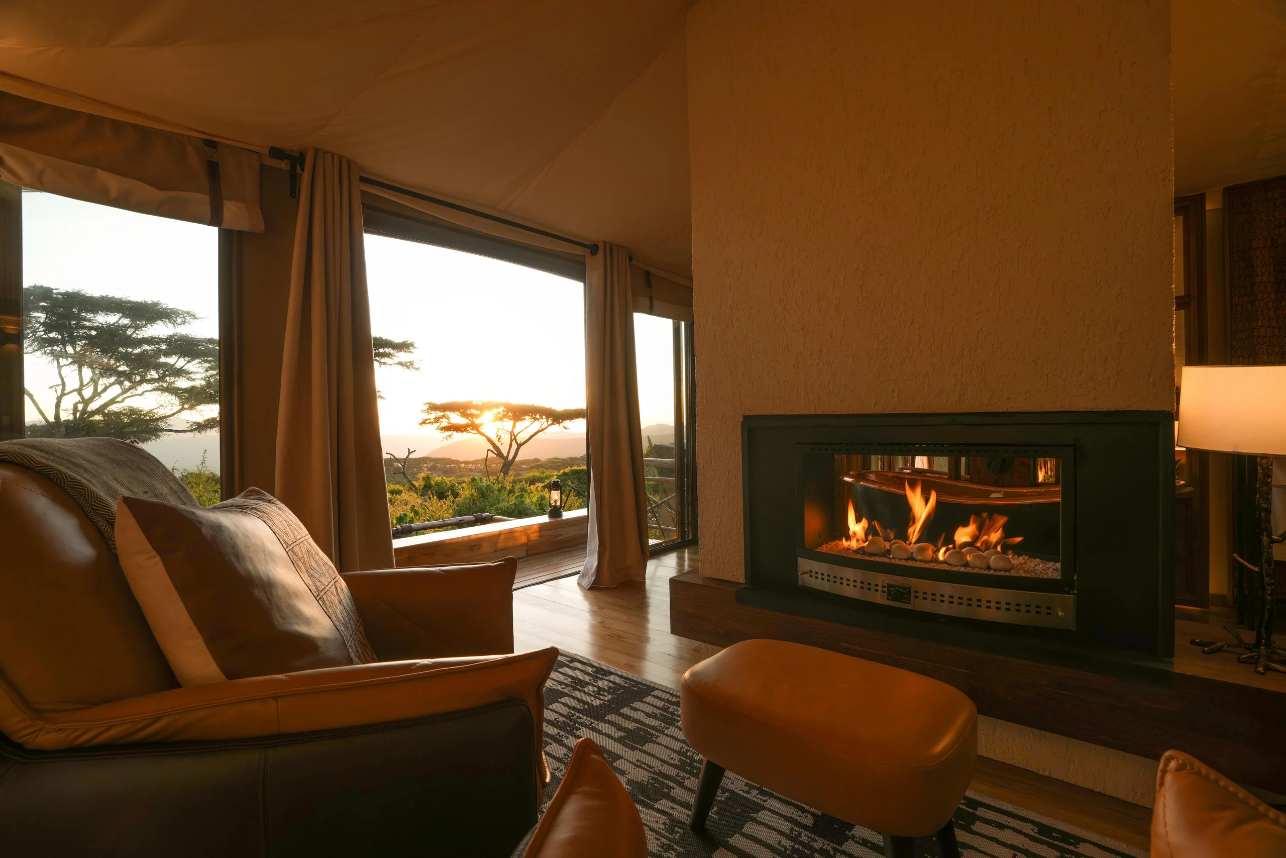 A suite sitting room with a fireplace and the crater view