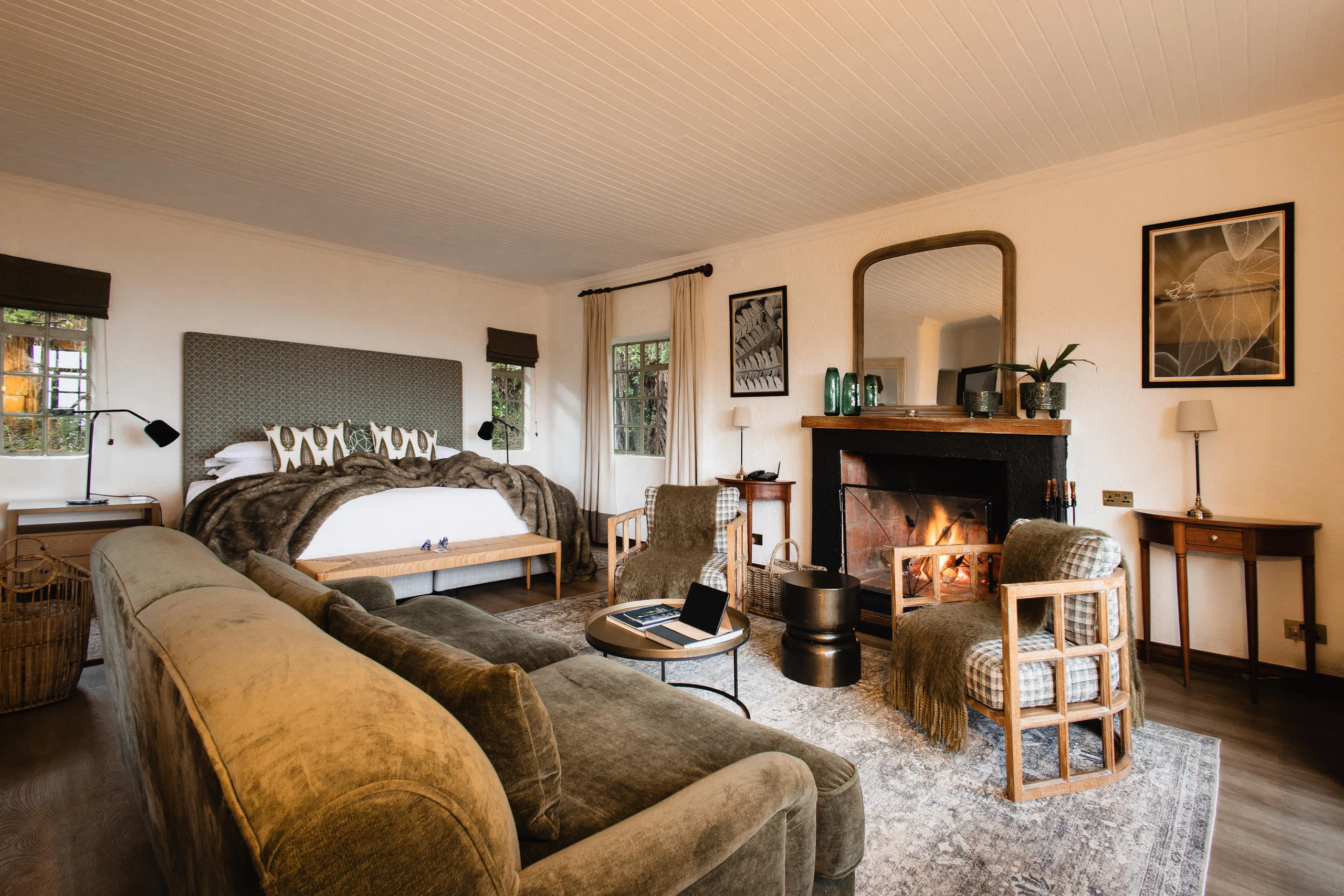 The lounge with a fireplace and velvet sofas