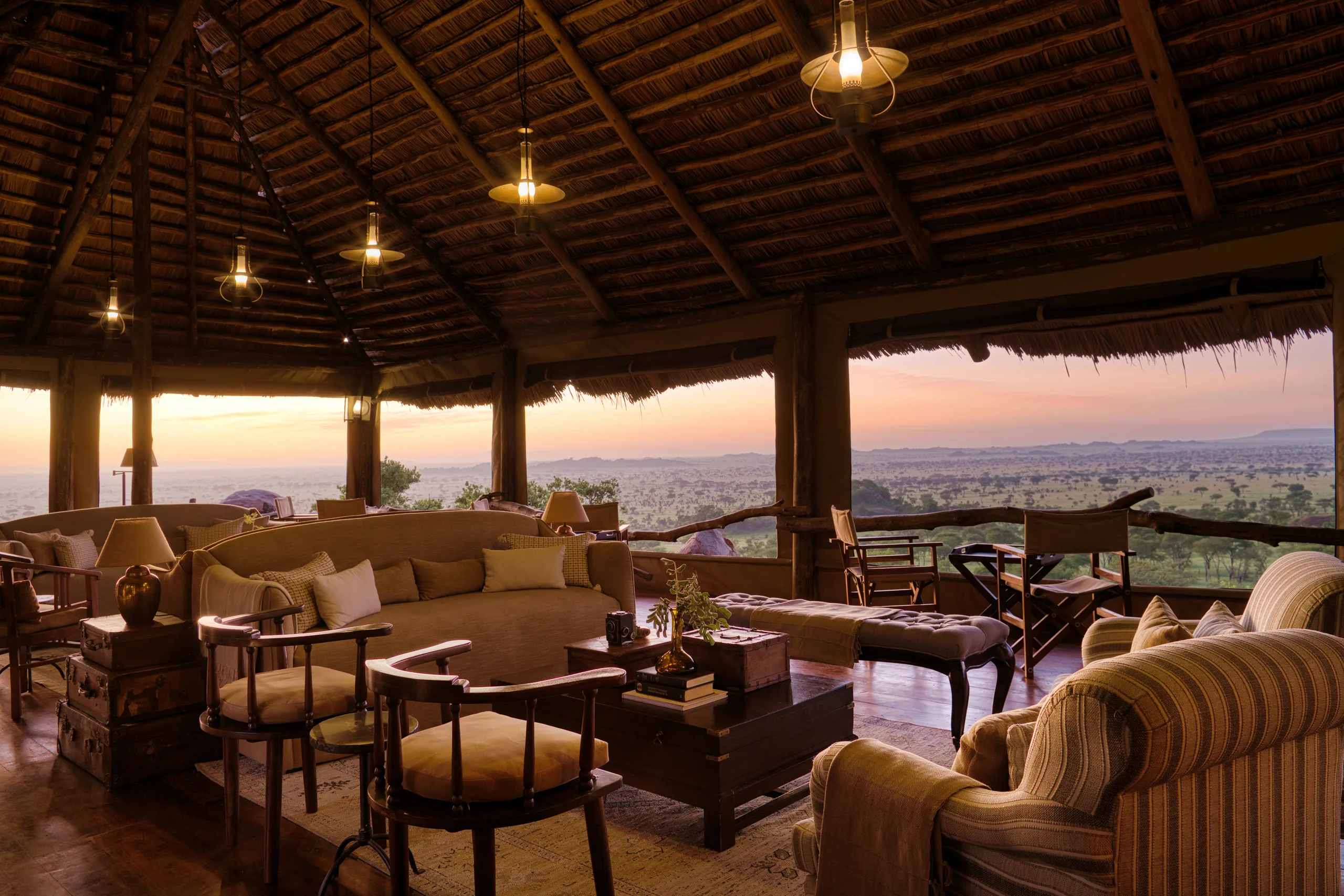 The thatched lounge overlooking the plains at sunset at Serengeti Pioneer Camp